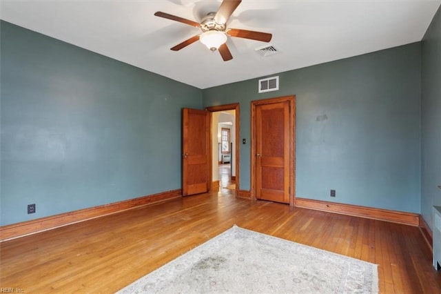 unfurnished room with ceiling fan and wood-type flooring