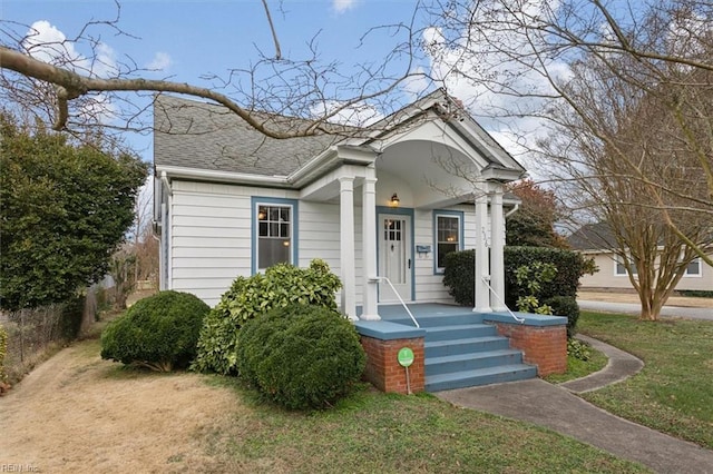 bungalow-style home with a front yard