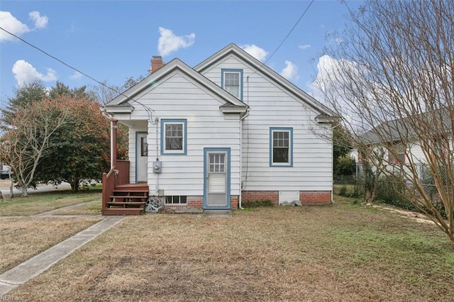 rear view of property with a lawn