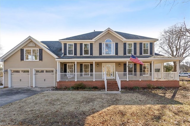 colonial home with a garage and a porch