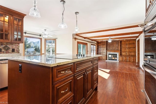 kitchen featuring black electric stovetop, tasteful backsplash, a center island, hanging light fixtures, and beamed ceiling