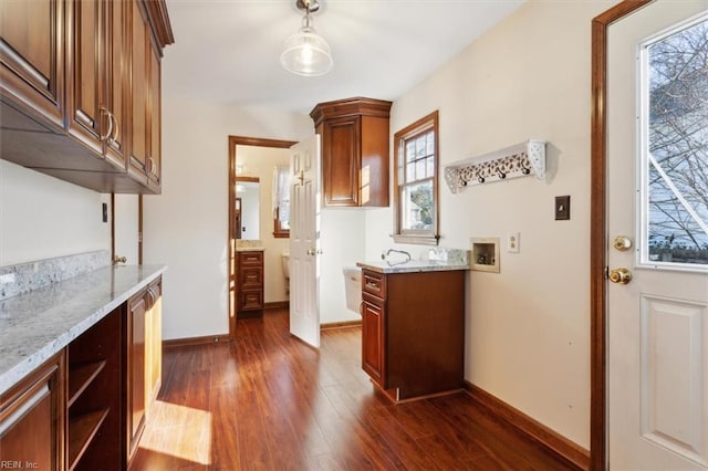 kitchen with dark hardwood / wood-style flooring and light stone countertops