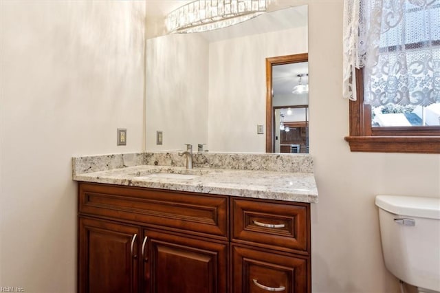 bathroom featuring toilet and vanity