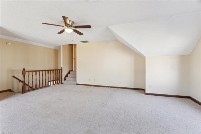 additional living space with ceiling fan, vaulted ceiling, and light carpet