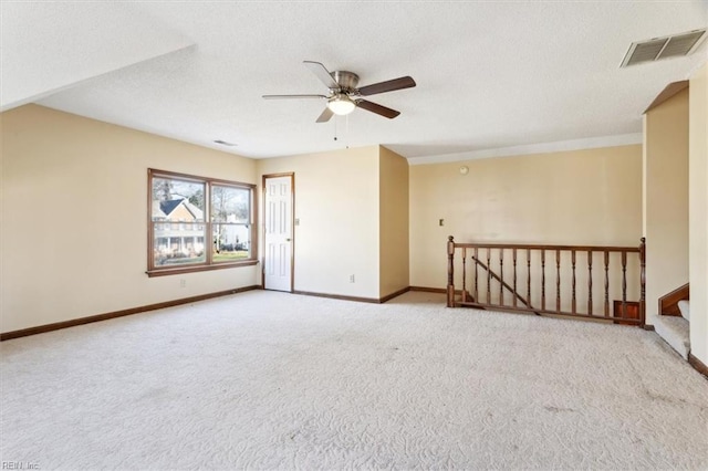 unfurnished room with ceiling fan and light colored carpet