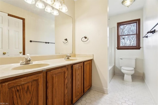 bathroom with toilet, tile patterned flooring, and vanity