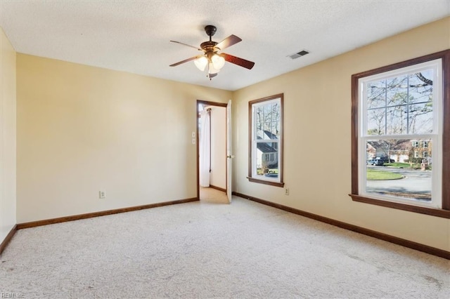 empty room with light carpet and ceiling fan