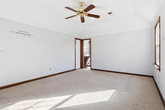 carpeted empty room featuring ceiling fan, ornamental molding, and a raised ceiling