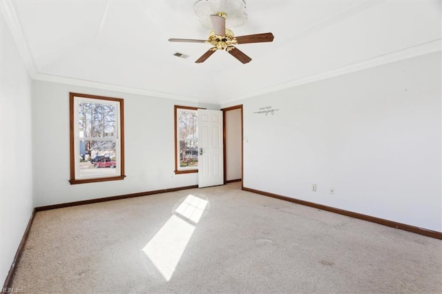 spare room featuring ceiling fan, light colored carpet, and ornamental molding