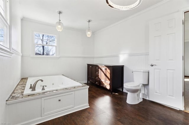 bathroom with toilet, a bathing tub, crown molding, and hardwood / wood-style flooring