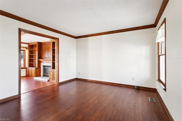 unfurnished living room with a textured ceiling, dark hardwood / wood-style flooring, and ornamental molding