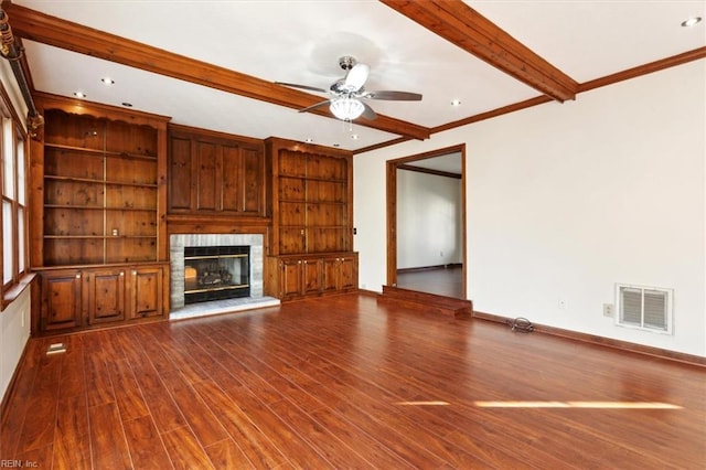 unfurnished living room featuring hardwood / wood-style flooring, ceiling fan, a fireplace, ornamental molding, and built in shelves