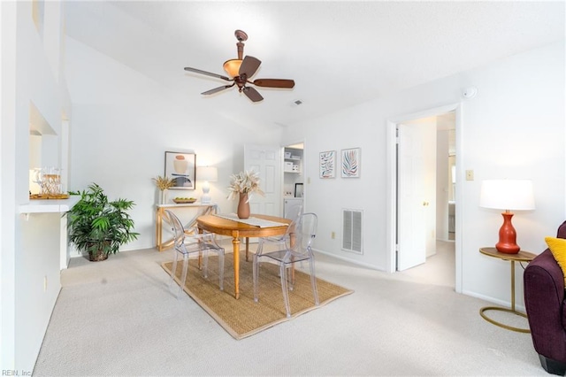 carpeted dining room featuring lofted ceiling and ceiling fan