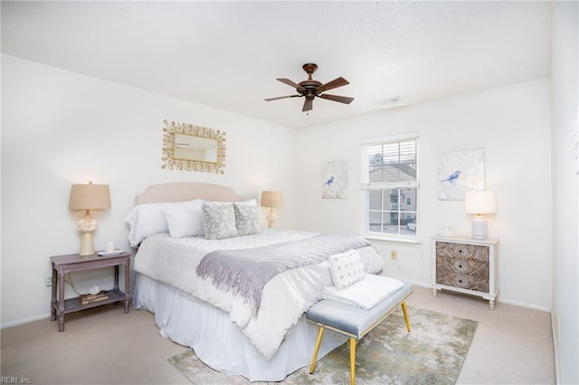 bedroom with ceiling fan and light carpet