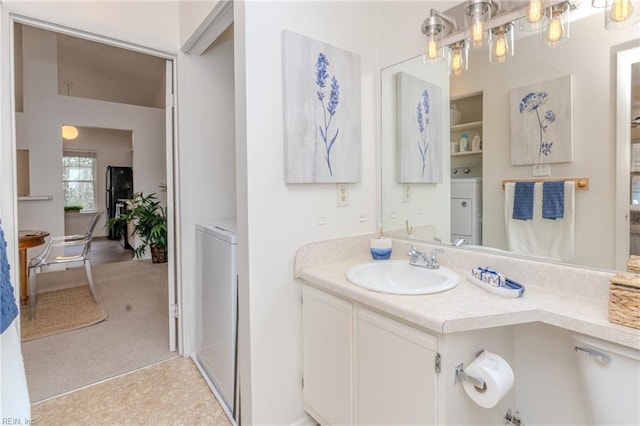 bathroom with washer / dryer and vanity