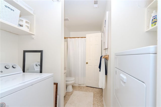 clothes washing area with separate washer and dryer