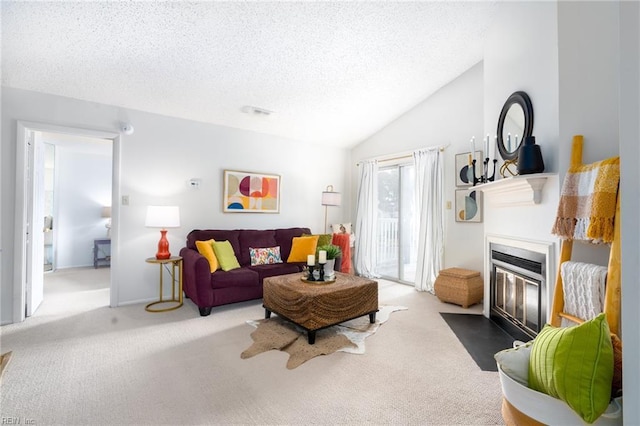 carpeted living room featuring lofted ceiling and a textured ceiling