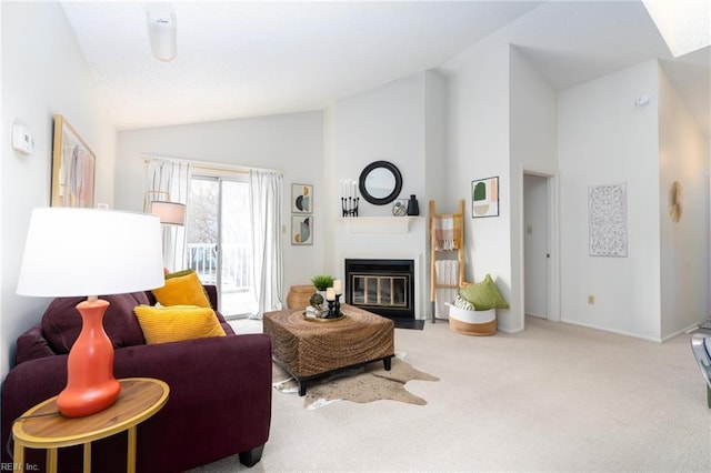 carpeted living room with high vaulted ceiling