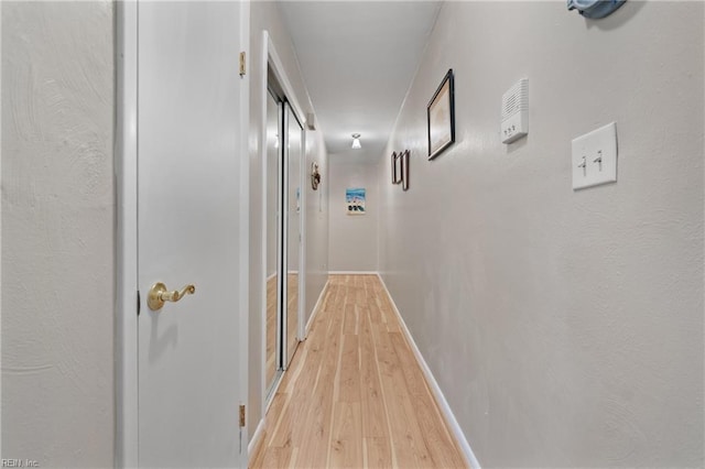 corridor with light hardwood / wood-style floors