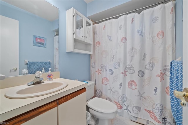 bathroom with toilet, vanity, and a shower with curtain