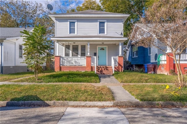 front of property with a front yard and covered porch