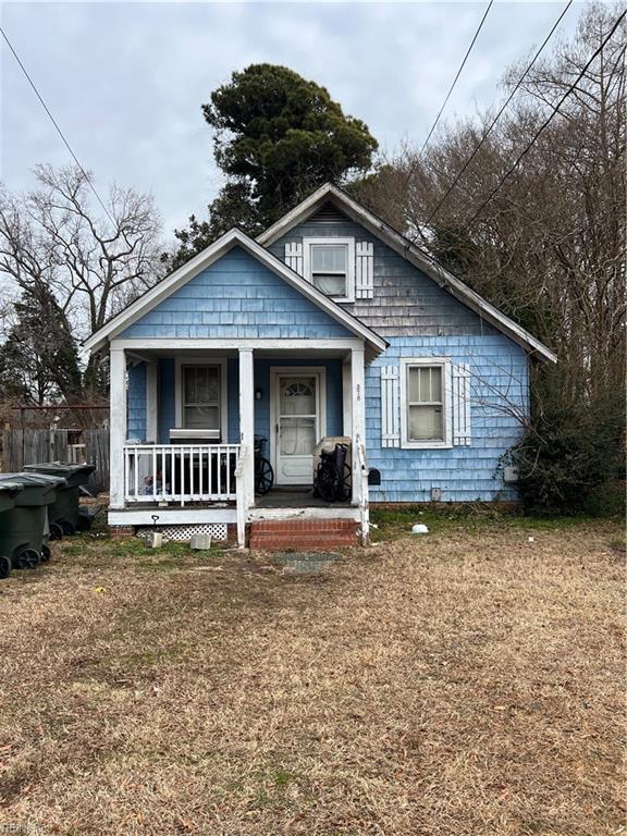 bungalow-style house with a porch and a front yard