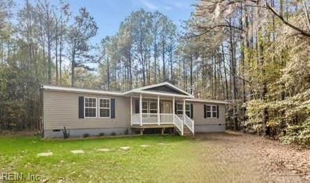 rear view of property featuring a yard