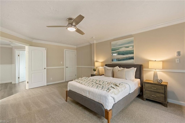 carpeted bedroom featuring ceiling fan and crown molding