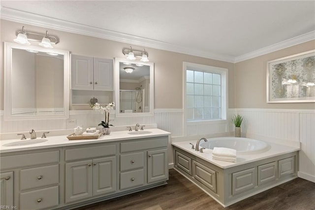 bathroom with ornamental molding, independent shower and bath, vanity, and wood-type flooring