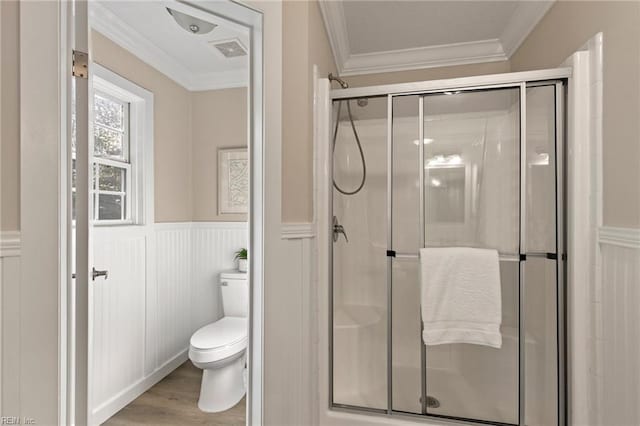 bathroom featuring toilet, an enclosed shower, crown molding, and wood-type flooring