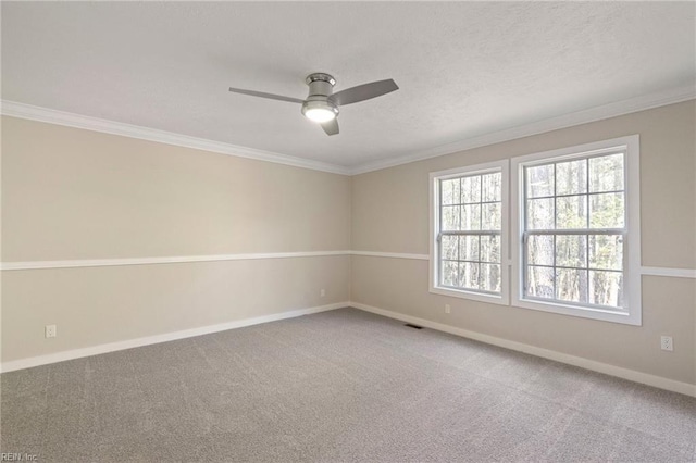 carpeted empty room featuring ornamental molding and ceiling fan