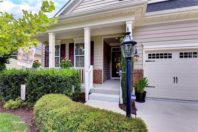 doorway to property featuring covered porch and a garage