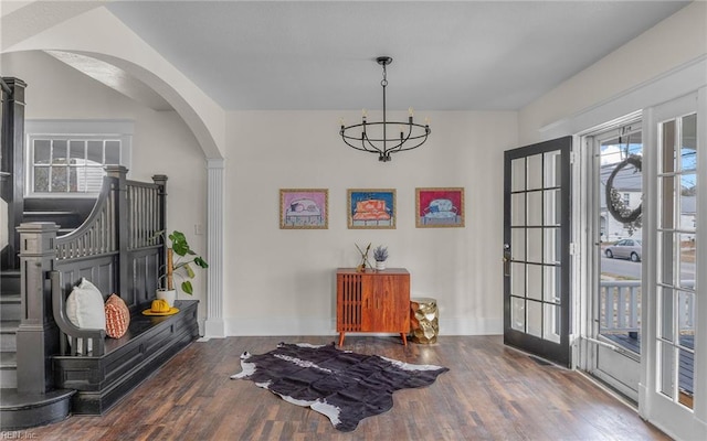 foyer featuring french doors, dark hardwood / wood-style floors, and a notable chandelier