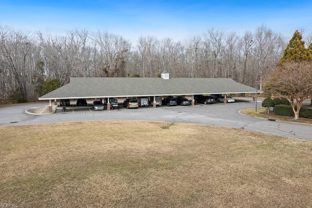 view of front facade with a front yard and a carport