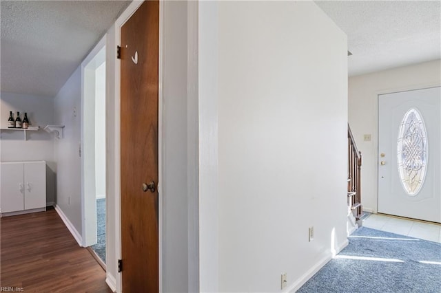 hall with a textured ceiling