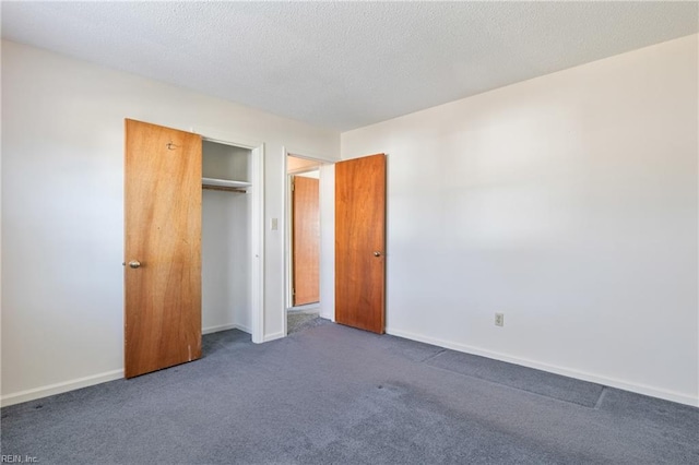 unfurnished bedroom featuring a closet and dark colored carpet