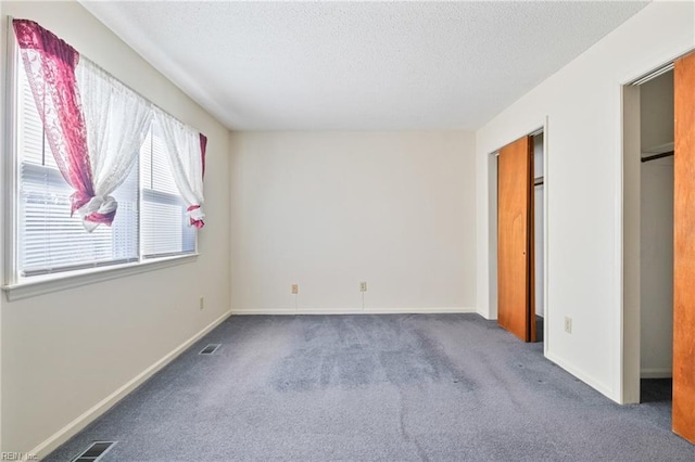 unfurnished bedroom with dark colored carpet