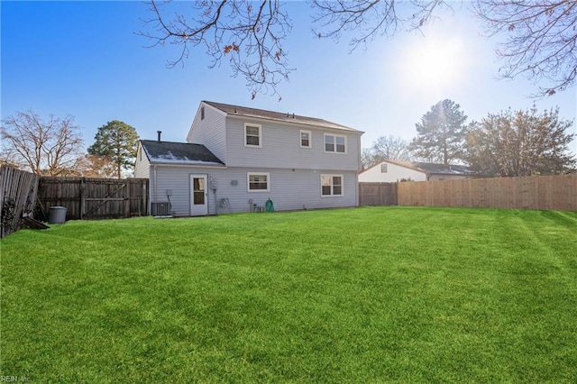 rear view of property with a lawn and central AC