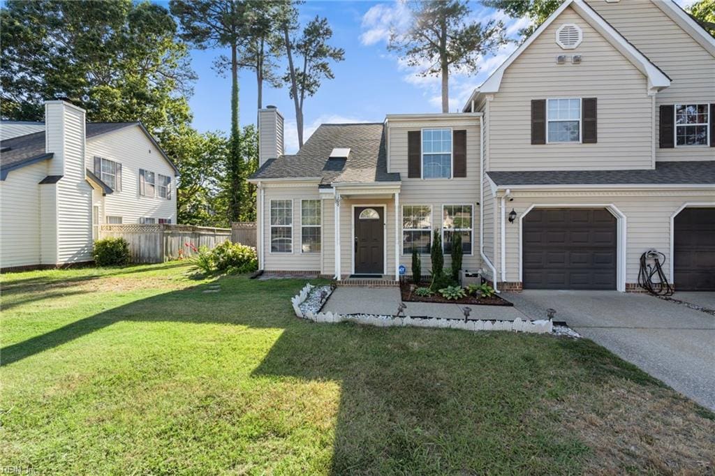 view of front facade featuring a front yard and a garage