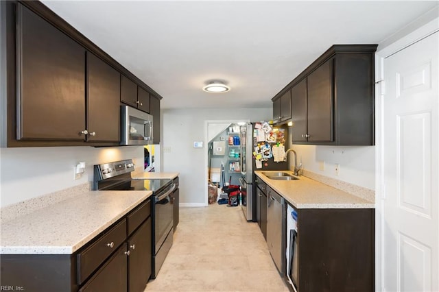 kitchen featuring sink, stainless steel appliances, and dark brown cabinetry