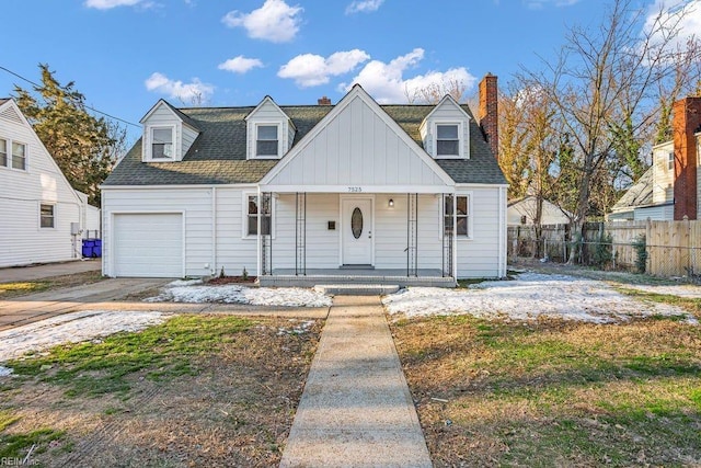 new england style home featuring a garage and covered porch