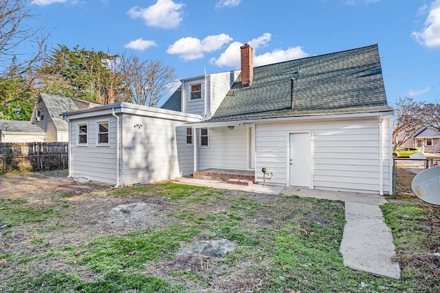 back of house featuring an outbuilding