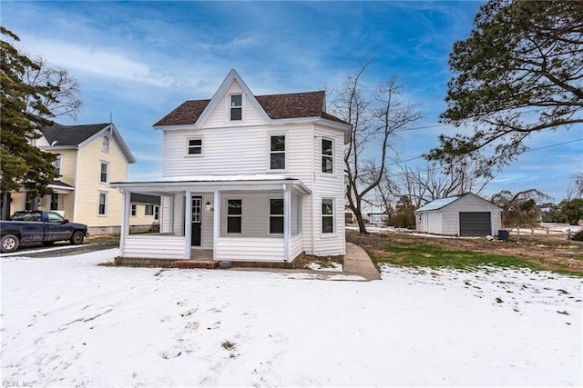 view of front of property with a garage, an outdoor structure, and covered porch