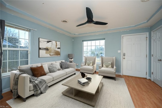 living room with ceiling fan and light wood-type flooring