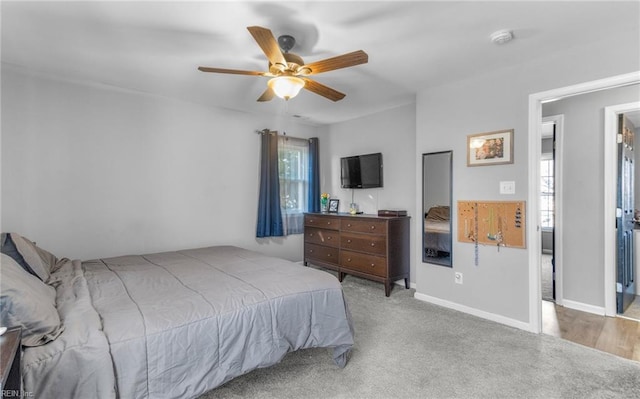 carpeted bedroom featuring ceiling fan and multiple windows