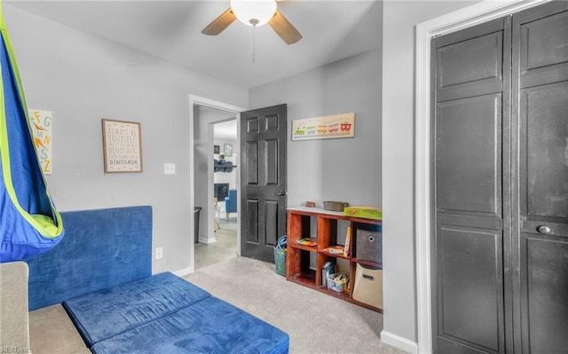 bedroom featuring ceiling fan and light carpet