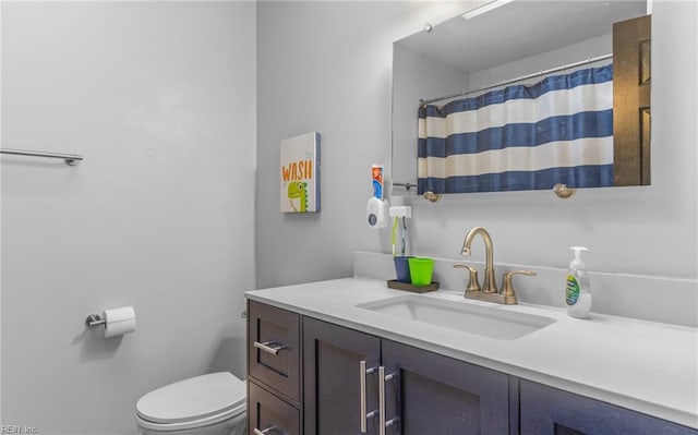 bathroom with toilet and vanity