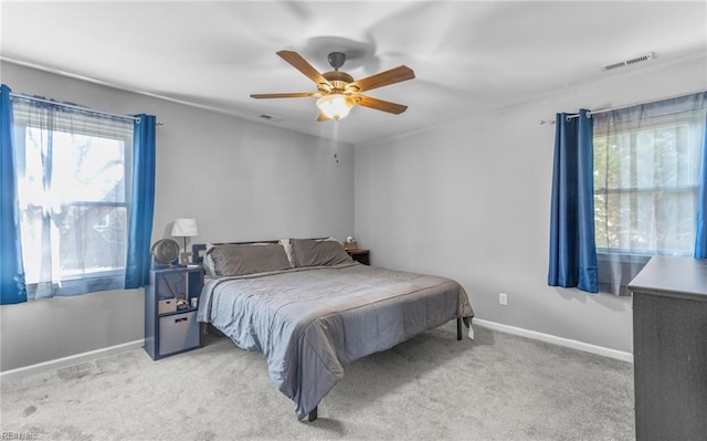 bedroom with light carpet and ceiling fan