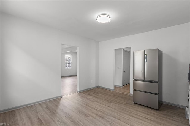 spare room with light wood-type flooring