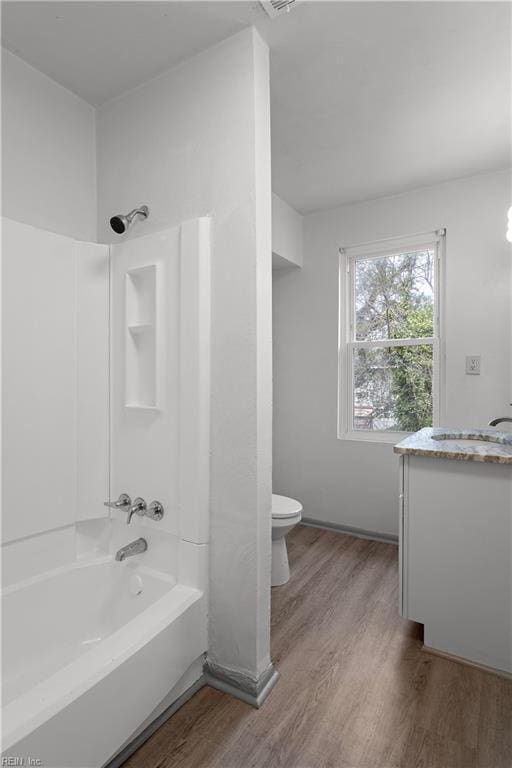 full bathroom featuring shower / bathing tub combination, vanity, toilet, and hardwood / wood-style floors